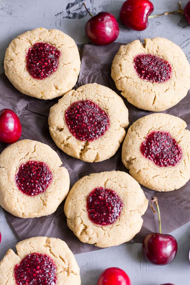 These chewy lemon almond thumbprint cookies are filled with cherry chia jam and are healthy, paleo, vegan, kid approved, and easy to make.  They taste buttery and decadent but are gluten free and dairy free!