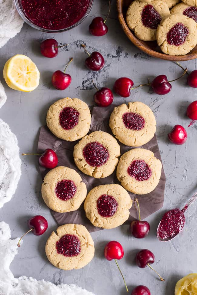 These chewy lemon almond thumbprint cookies are filled with cherry chia jam and are healthy, paleo, vegan, kid approved, and easy to make.  They taste buttery and decadent but are gluten free and dairy free!