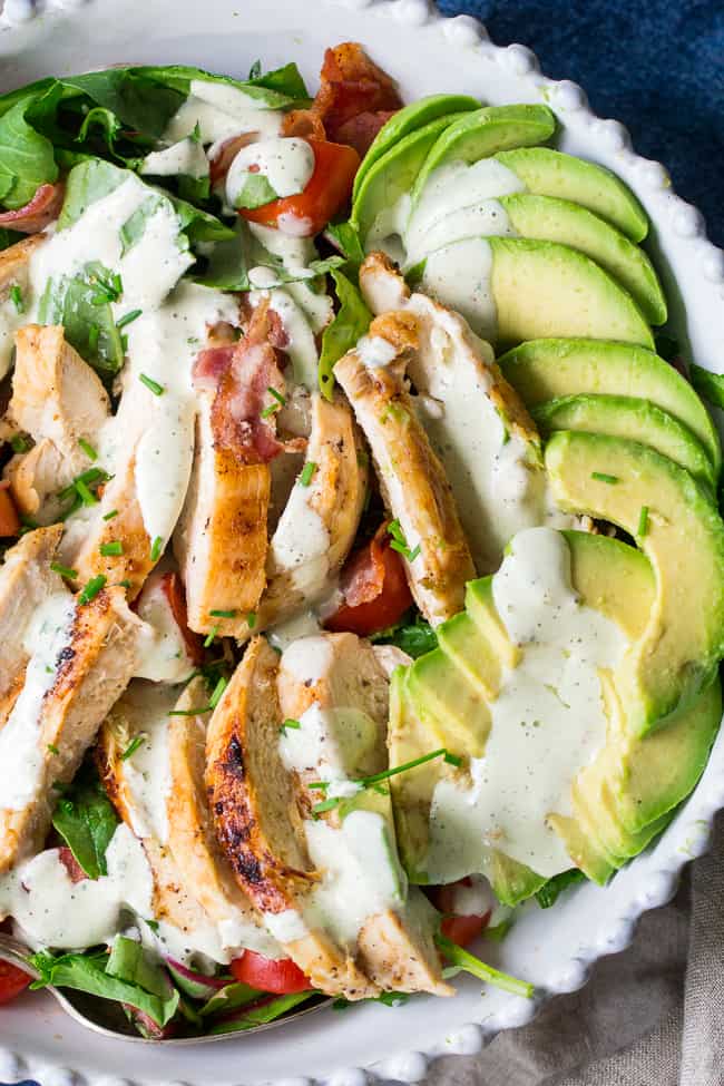 This grilled chicken BLT salad includes all your favorites - crispy bacon, perfectly seasoned grilled chicken, cherry tomatoes, and avocado! It's topped with a healthy paleo & Whole30 friendly peppercorn ranch that might just become your new favorite salad dressing! Dairy-free, gluten-free, even kid approved!