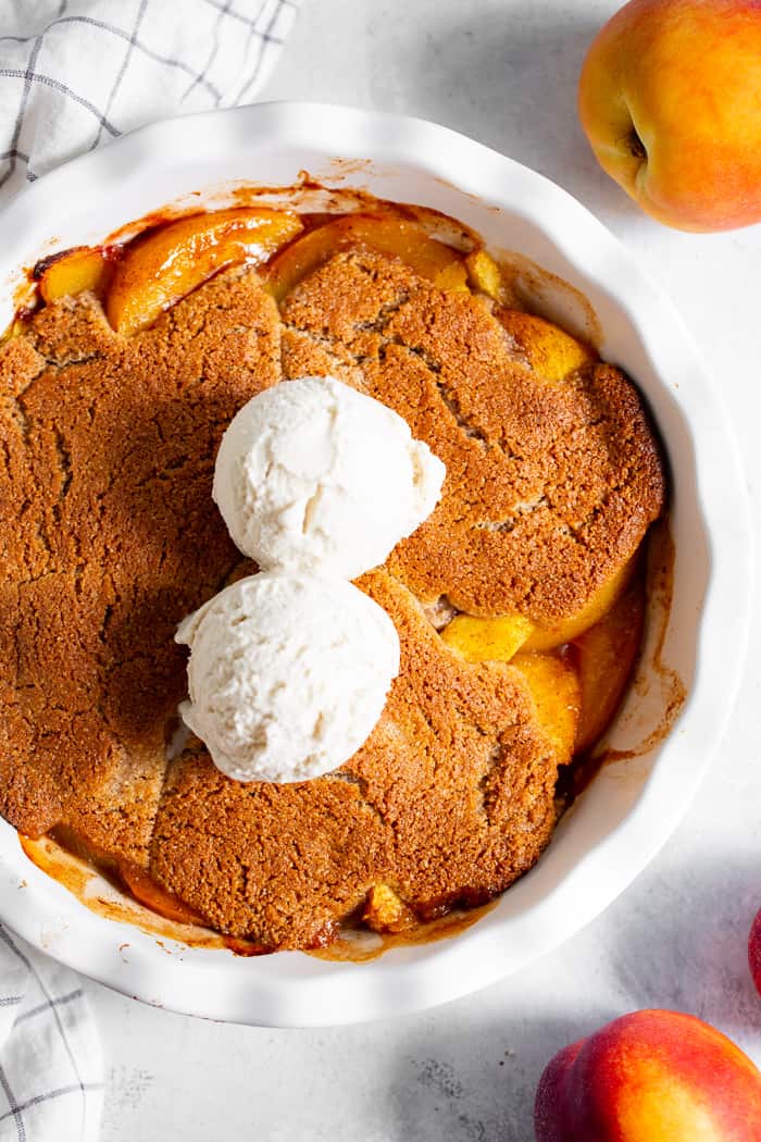 Take advantage of peach season with this paleo and vegan peach cobbler!  It's sweetened with unrefined coconut sugar and spiced with a touch of sweet cinnamon, with a warm and crisp grain-free pastry topping that's downright addicting.  A great gluten free, dairy free, egg free dessert for summer!