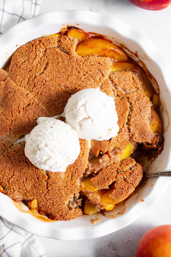 Take advantage of peach season with this paleo and vegan peach cobbler!  It's sweetened with unrefined coconut sugar and spiced with a touch of sweet cinnamon, with a warm and crisp grain-free pastry topping that's downright addicting.  A great gluten free, dairy free, egg free dessert for summer!