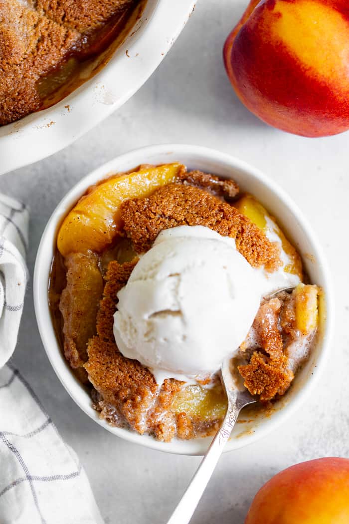 Take advantage of peach season with this paleo and vegan peach cobbler!  It's sweetened with unrefined coconut sugar and spiced with a touch of sweet cinnamon, with a warm and crisp grain-free pastry topping that's downright addicting.  A great gluten free, dairy free, egg free dessert for summer!