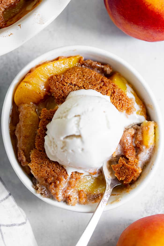 Take advantage of peach season with this paleo and vegan peach cobbler!  It's sweetened with unrefined coconut sugar and spiced with a touch of sweet cinnamon, with a warm and crisp grain-free pastry topping that's downright addicting.  A great gluten free, dairy free, egg free dessert for summer!