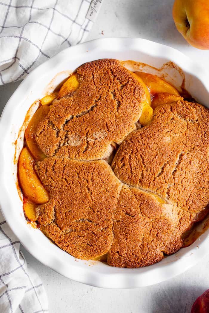 Take advantage of peach season with this paleo and vegan peach cobbler!  It's sweetened with unrefined coconut sugar and spiced with a touch of sweet cinnamon, with a warm and crisp grain-free pastry topping that's downright addicting.  A great gluten free, dairy free, egg free dessert for summer!