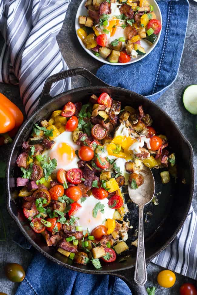 This one-pan sweet potato hash is loaded with summer veggies, bacon and served with or without baked eggs - your choice!  It's delicious, filling and healthy any time of day making it perfect for breakfast, lunch or dinner.  It's paleo, whole30 friendly and low FODMAP too.