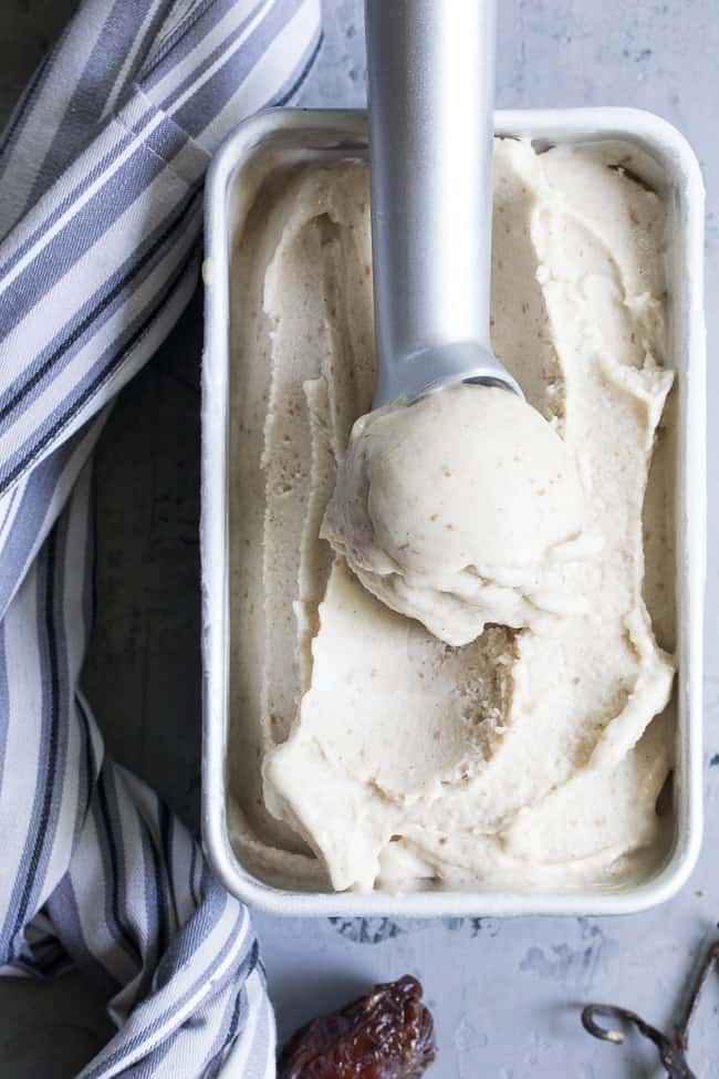 This dairy-free vanilla bean ice cream is made with coconut milk & cream and sweetened with dates for a naturally creamy texture and sweet flavor.  It's paleo and vegan, soy free and contains no refined sugar.  This healthy dessert is packed with vanilla flavor and ready for all your favorite toppings! 