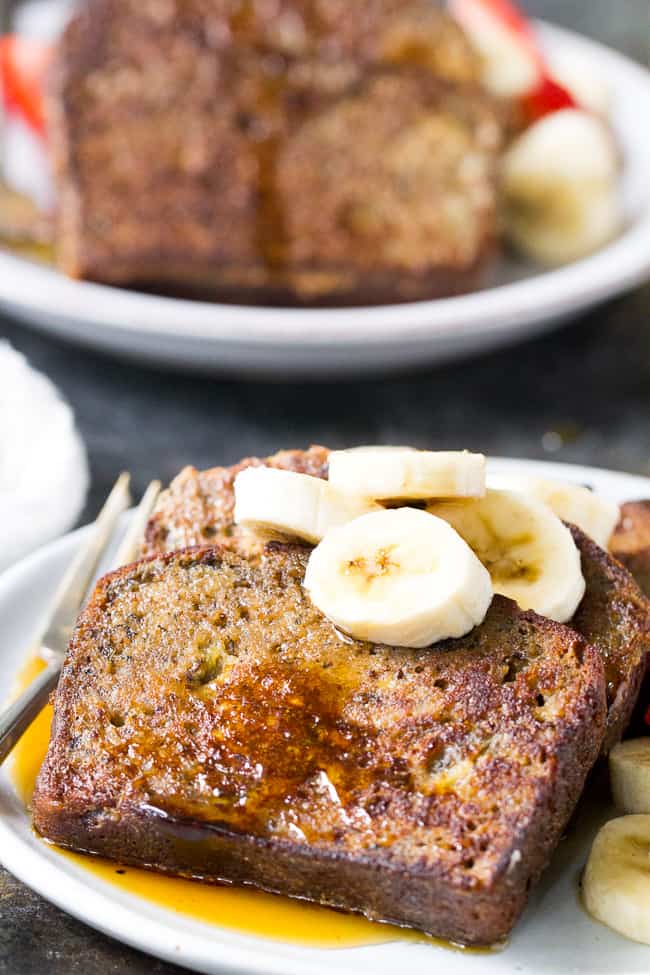 This Banana Bread French Toast is pure paleo breakfast comfort food!  Made with a hearty banana-sweetened grain free and paleo banana bread, it's perfect for a weekend breakfast treat when you're craving something indulgent.  Gluten free, dairy free, refined-sugar free.