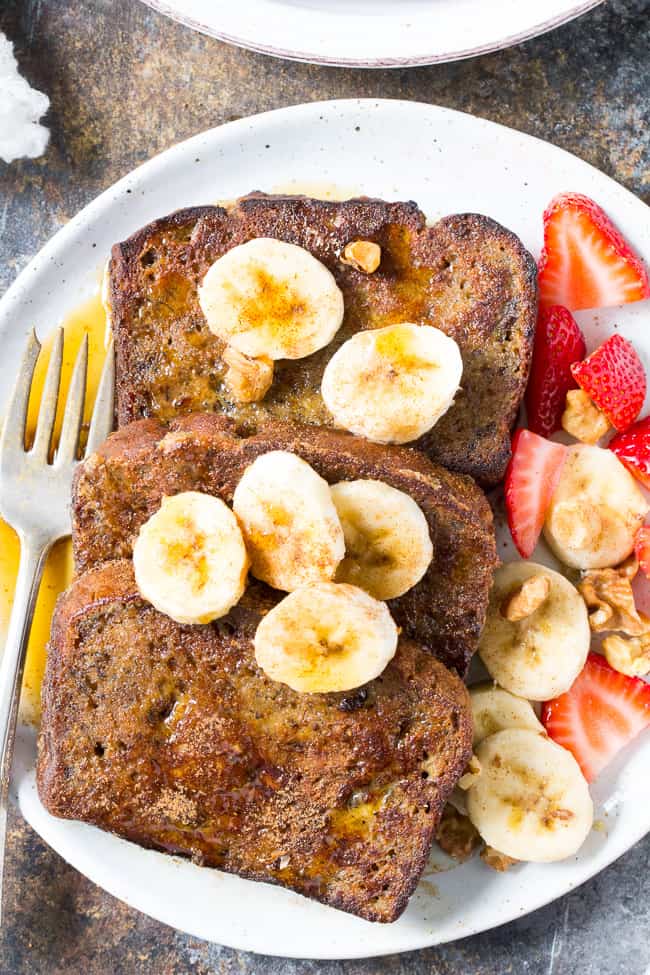 This Banana Bread French Toast is pure paleo breakfast comfort food!  Made with a hearty banana-sweetened grain free and paleo banana bread, it's perfect for a weekend breakfast treat when you're craving something indulgent.  Gluten free, dairy free, refined-sugar free.