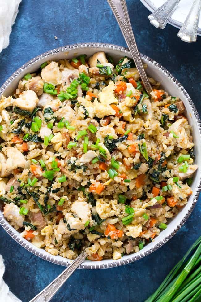 This cauliflower fried rice tastes just like the real thing (maybe better!) but it's much healthier and easy to make at home.  Loaded with flavor, protein, veggies and healthy fats, it makes a great weeknight meal that everyone will love.  Paleo, Whole30 compliant, low carb, kid approved!