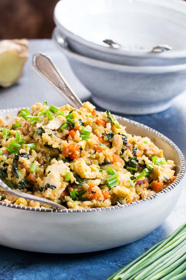 This cauliflower fried rice tastes just like the real thing (maybe better!) but it's much healthier and easy to make at home.  Loaded with flavor, protein, veggies and healthy fats, it makes a great weeknight meal that everyone will love.  Paleo, Whole30 compliant, low carb, kid approved!