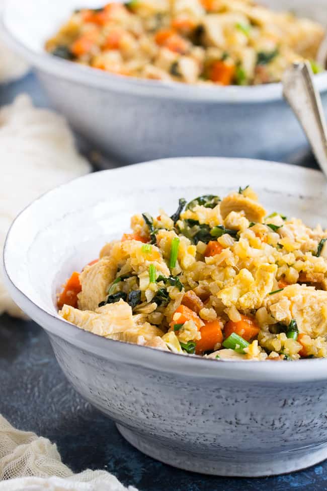 This cauliflower fried rice tastes just like the real thing (maybe better!) but it's much healthier and easy to make at home.  Loaded with flavor, protein, veggies and healthy fats, it makes a great weeknight meal that everyone will love.  Paleo, Whole30 compliant, low carb, kid approved!