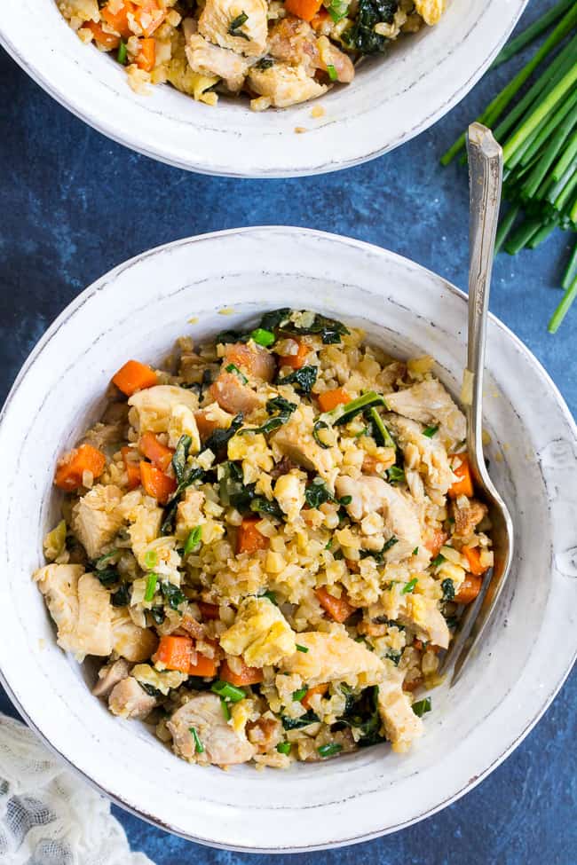 This cauliflower fried rice tastes just like the real thing (maybe better!) but it's much healthier and easy to make at home.  Loaded with flavor, protein, veggies and healthy fats, it makes a great weeknight meal that everyone will love.  Paleo, Whole30 compliant, low carb, kid approved!