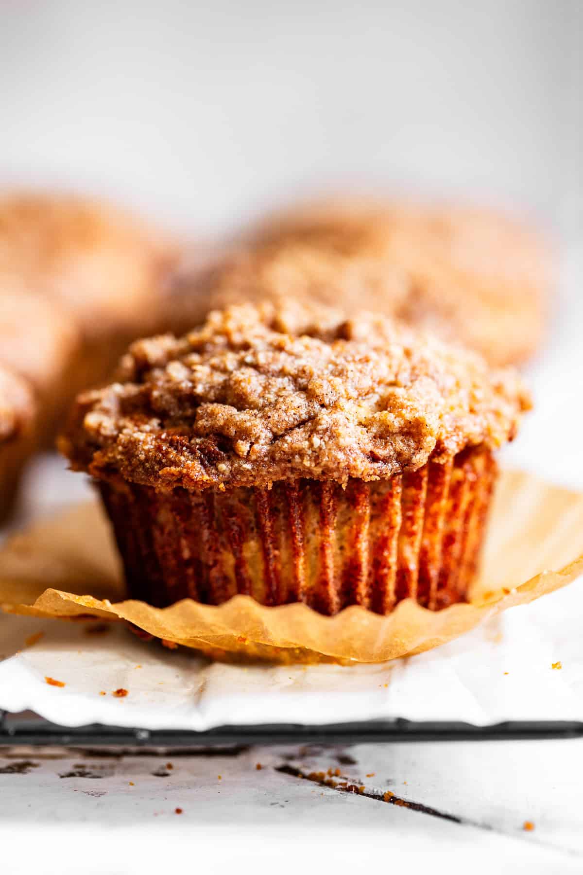 Tall apple crumb muffin topped with cinnamon almond flour crumble