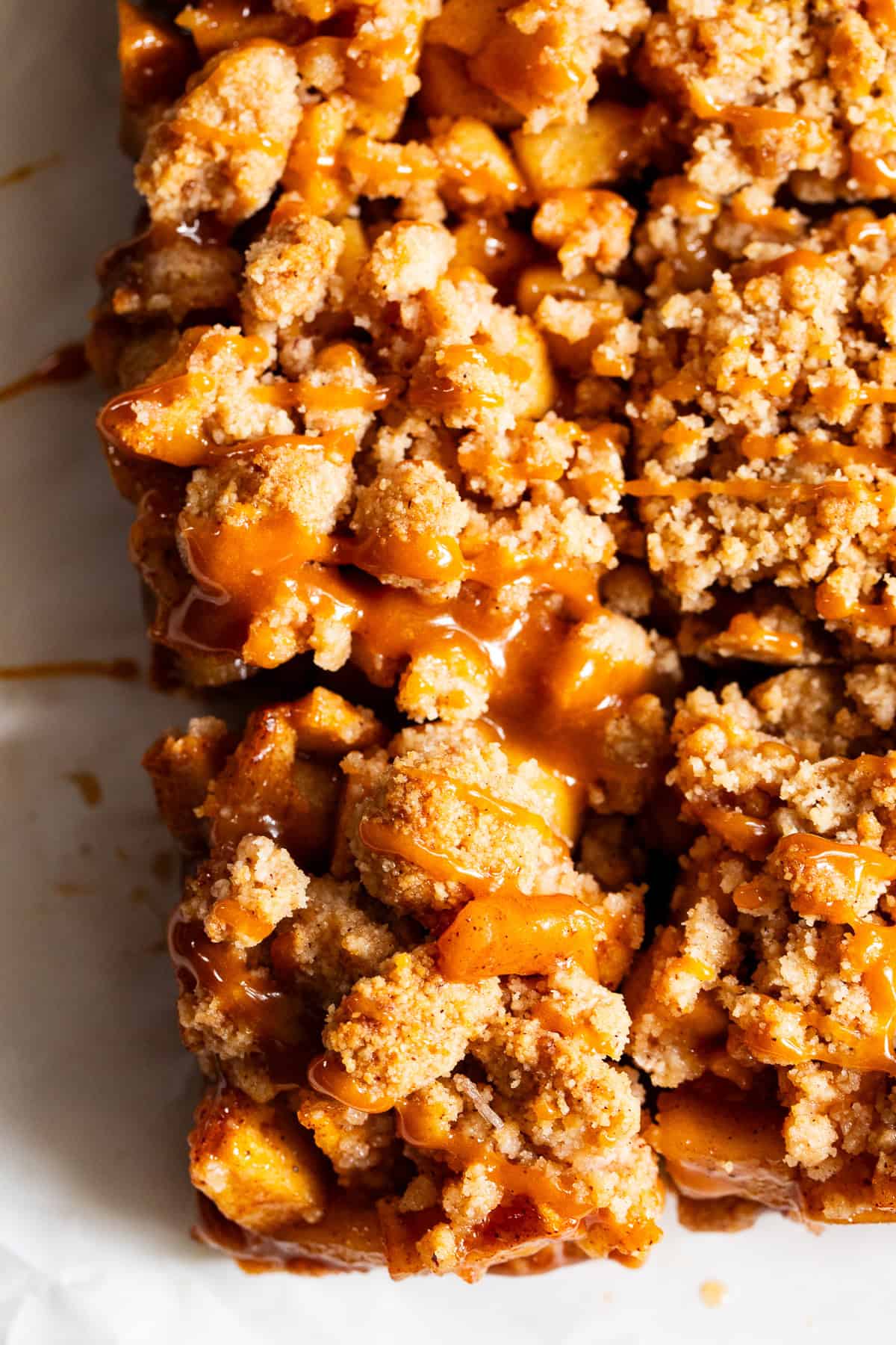 Paleo apple pie crumble bars stacked with homemade caramel drizzle