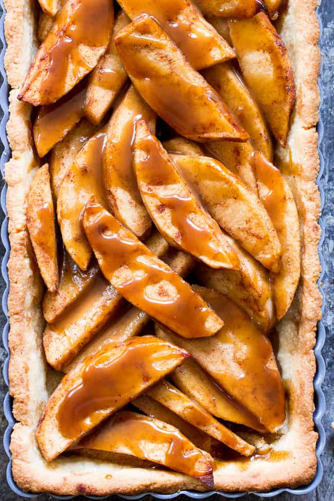 This gorgeous salted caramel apple tart is an irresistible fall dessert and easier than you think!  It begins with a buttery grain free pastry crust filled with juicy apples and topped with an easy dairy free salted caramel sauce.  Gluten free, grain free, dairy-free option, paleo, and family approved!