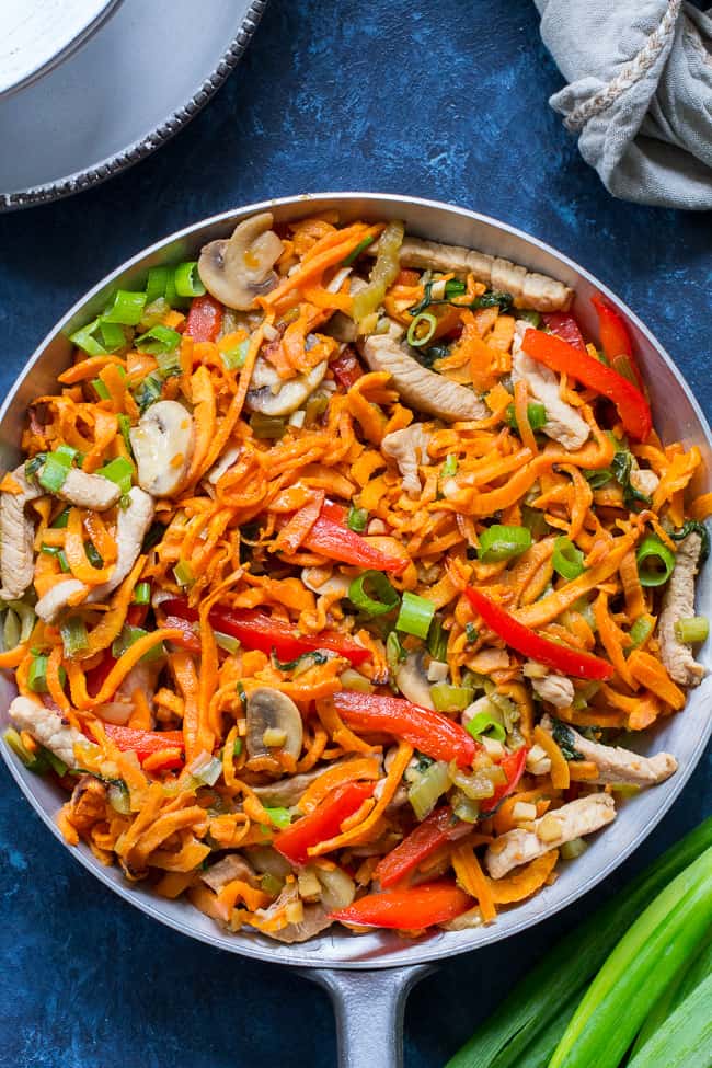 This paleo and Whole30 spin on veggie and pork lo mein uses sweet potato noodles for a delicious real-food meal packed with the traditional flavors of garlic, sesame and ginger.  High in protein, fiber, and healthy fats for a filling lunch or dinner that's grain free, soy free, gluten-free and paleo! 