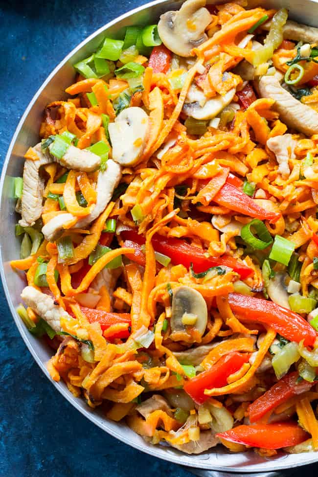 This paleo and Whole30 spin on veggie and pork lo mein uses sweet potato noodles for a delicious real-food meal packed with the traditional flavors of garlic, sesame and ginger.  High in protein, fiber, and healthy fats for a filling lunch or dinner that's grain free, soy free, gluten-free and paleo! 