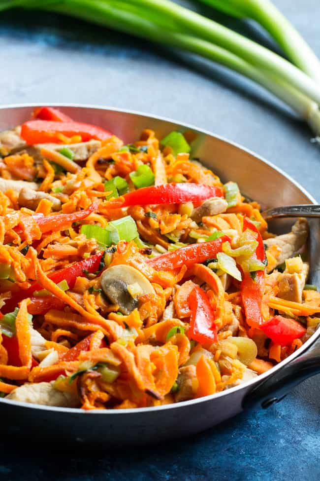 This paleo and Whole30 spin on veggie and pork lo mein uses sweet potato noodles for a delicious real-food meal packed with the traditional flavors of garlic, sesame and ginger.  High in protein, fiber, and healthy fats for a filling lunch or dinner that's grain free, soy free, gluten-free and paleo! 