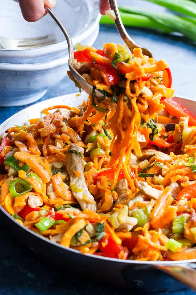 This paleo and Whole30 spin on veggie and pork lo mein uses sweet potato noodles for a delicious real-food meal packed with the traditional flavors of garlic, sesame and ginger.  High in protein, fiber, and healthy fats for a filling lunch or dinner that's grain free, soy free, gluten-free and paleo! 