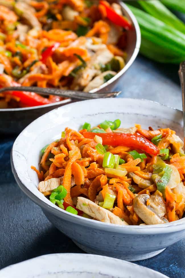 This paleo and Whole30 spin on veggie and pork lo mein uses sweet potato noodles for a delicious real-food meal packed with the traditional flavors of garlic, sesame and ginger.  High in protein, fiber, and healthy fats for a filling lunch or dinner that's grain free, soy free, gluten-free and paleo! 