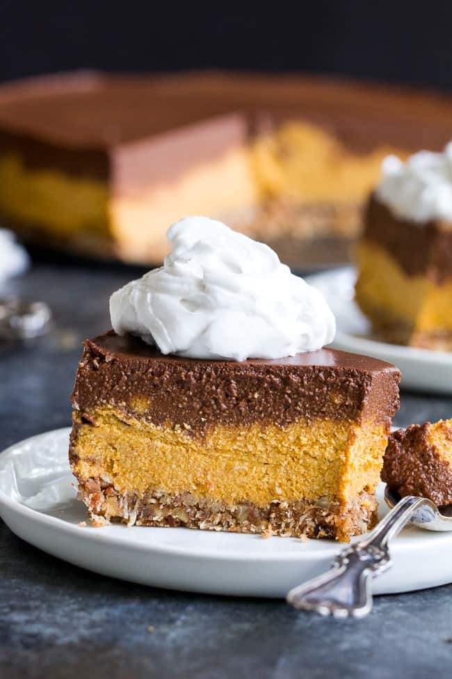 This no-bake chocolate pumpkin cashew cheesecake is a deliciously rich and creamy dessert for the holidays or any special occasion!  Two decadent vegan cheesecake layers are poured over a pecan, coconut and date crust and chilled to silky smooth perfection.  Paleo, vegan, dairy-free, gluten-free and family approved!