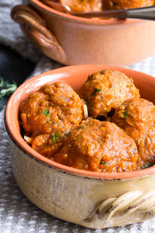 Savory pumpkin turkey meatballs in a creamy, dairy-free, paleo and Whole30 harvest tomato sauce with pumpkin and spices.  Makes a cozy, healthy and filling dinner and the leftovers are great for a next-day lunch.  Gluten-free, grain-free, kid approved and easy to make!