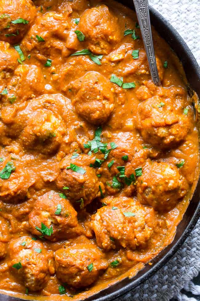 Savory pumpkin turkey meatballs in a creamy, dairy-free, paleo and Whole30 harvest tomato sauce with pumpkin and spices.  Makes a cozy, healthy and filling dinner and the leftovers are great for a next-day lunch.  Gluten-free, grain-free, kid approved and easy to make!