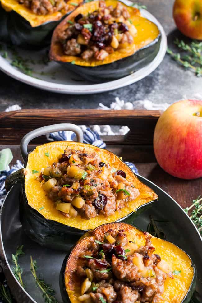 This Roasted Stuffed Acorn Squash is filled with all your favorites - sausage, apples, cranberries, onions, celery and savory herbs. The stuffing is packed with savory/sweet flavors and the perfect addition to a holiday gathering, or for any meal!  Paleo, gluten free, Whole30 compliant.