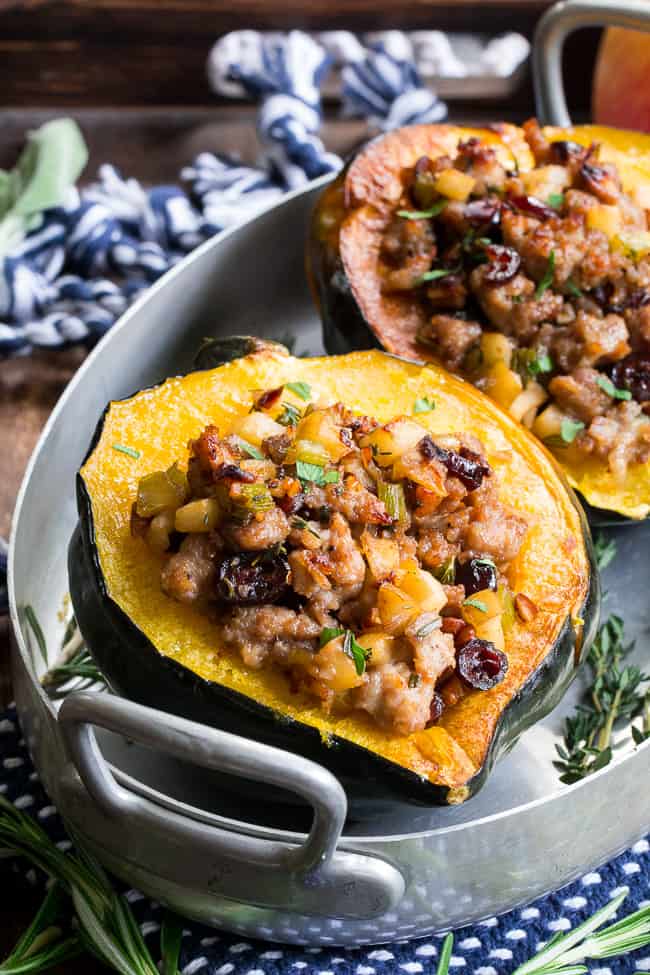 This Roasted Stuffed Acorn Squash is filled with all your favorites - sausage, apples, cranberries, onions, celery and savory herbs. The stuffing is packed with savory/sweet flavors and the perfect addition to a holiday gathering, or for any meal!  Paleo, gluten free, Whole30 compliant.