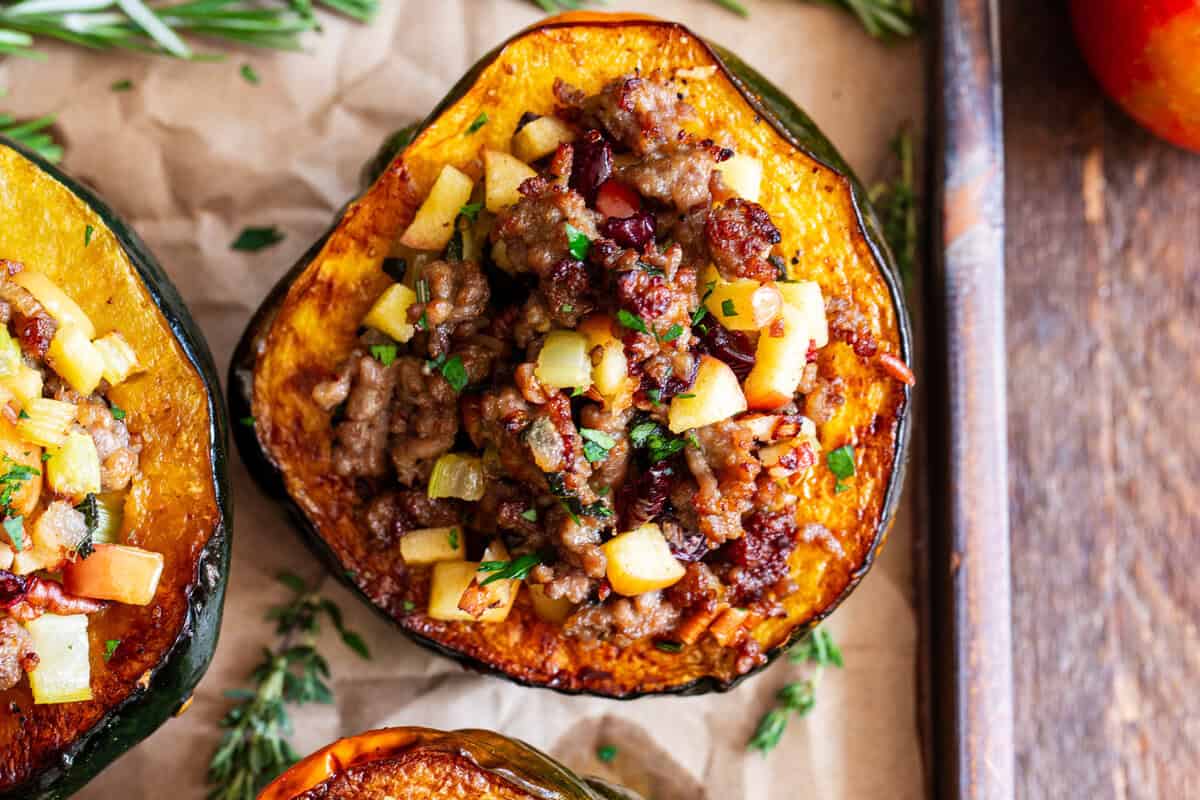 Stuffed acorn squash with sausage apples cranberries and pecans