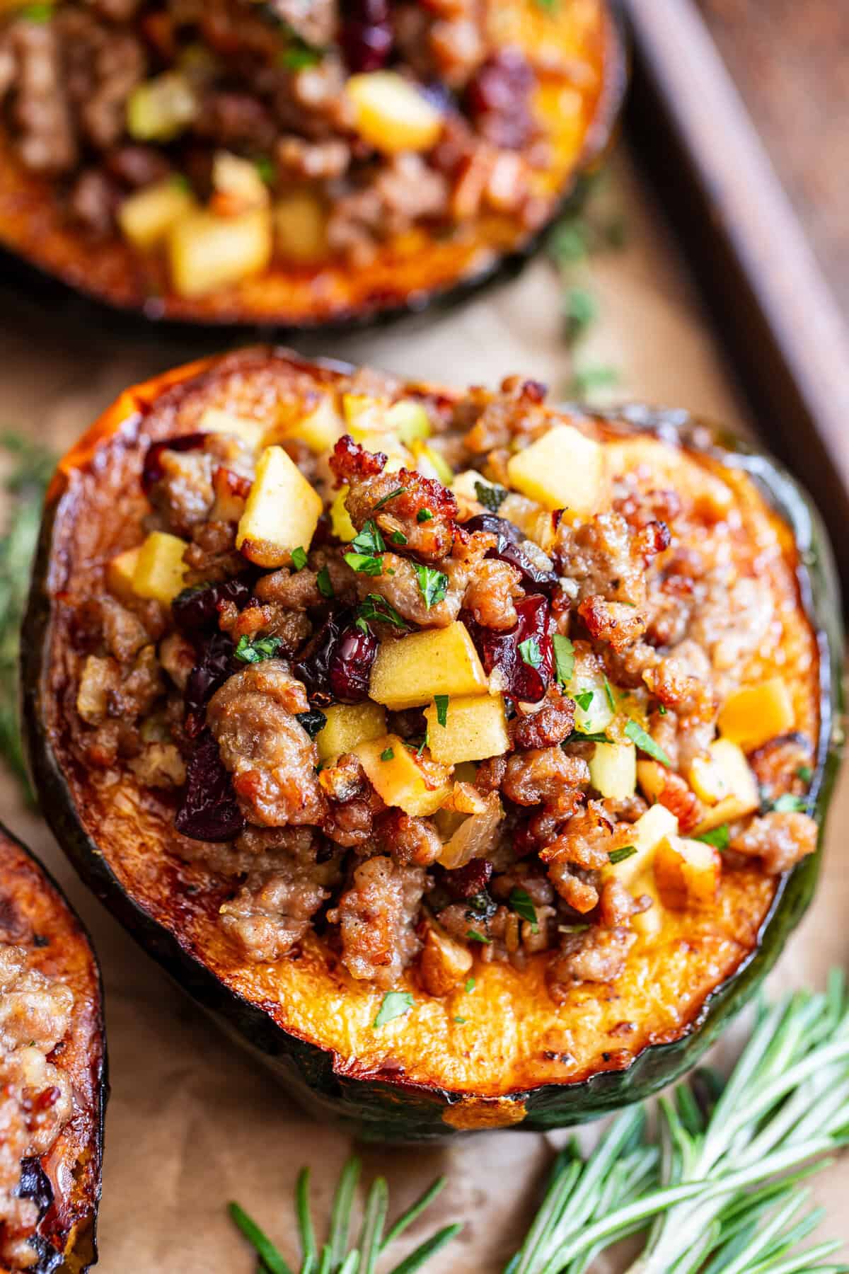 Stuffed acorn squash with sausage apples cranberries and pecans