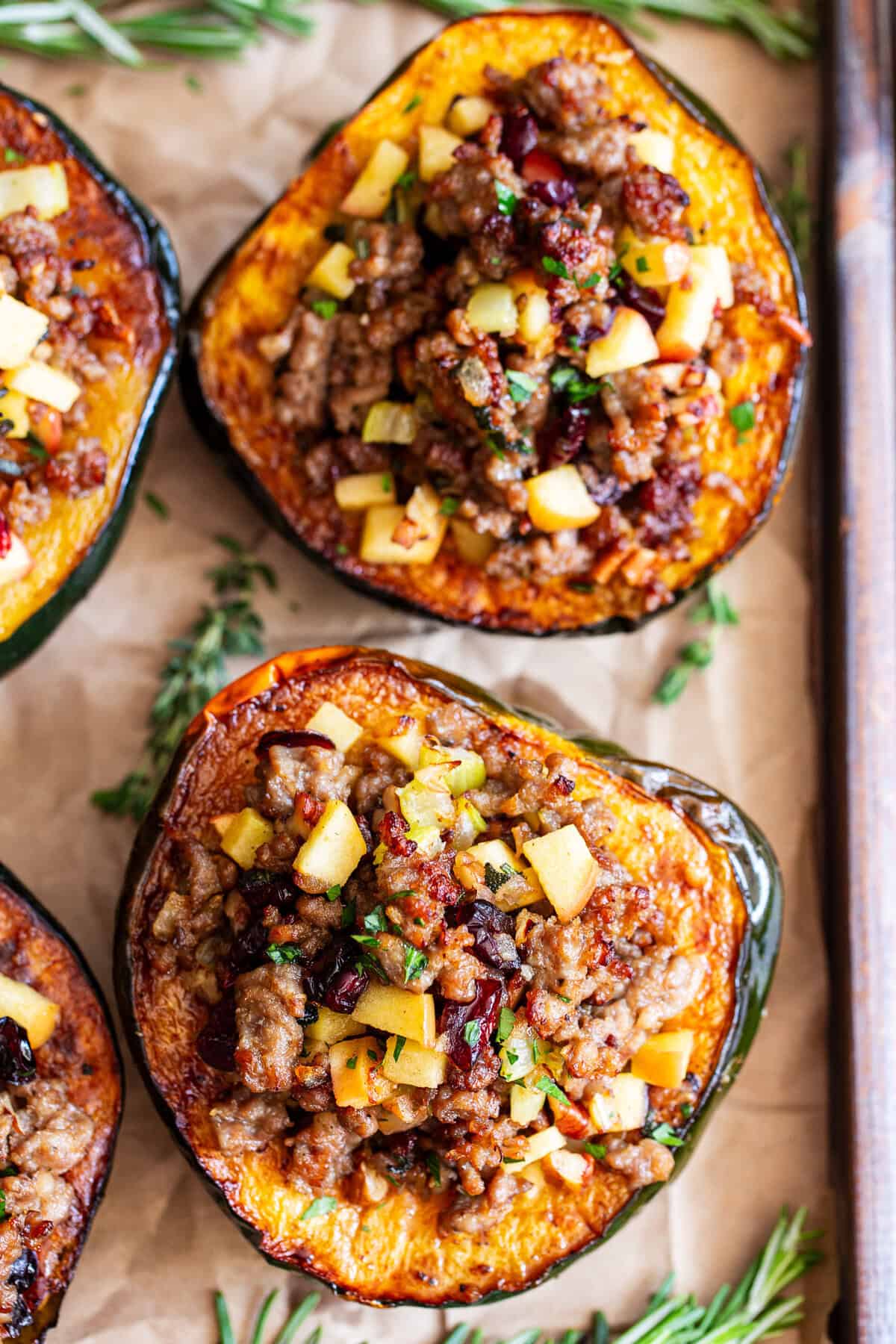 overhead shot of stuffed acorn squash with sausage apples cranberries and pecans