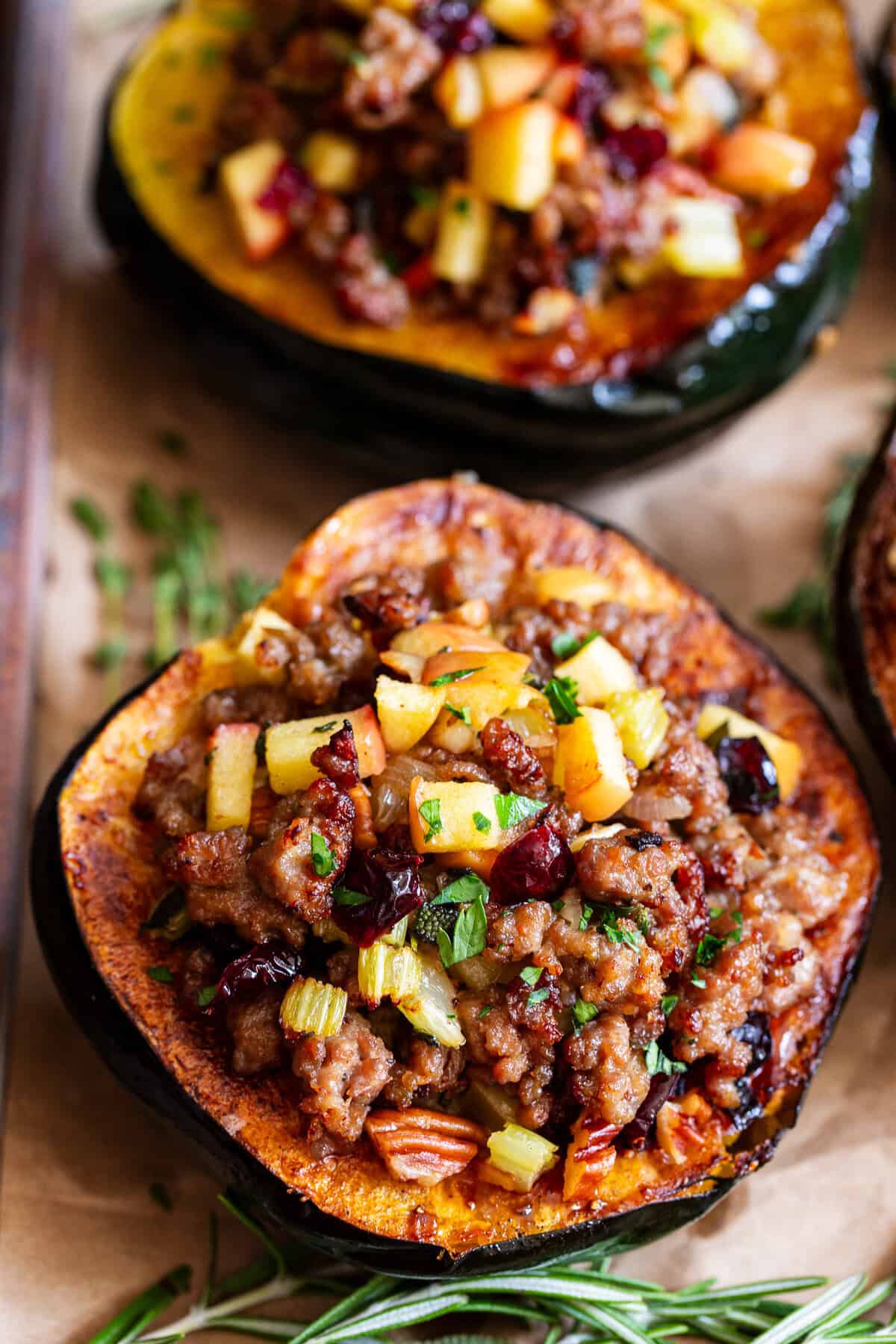 Stuffed acorn squash with sausage apples cranberries and pecans