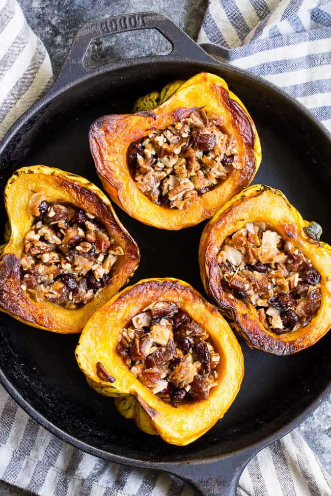 Winter squash is roasted, filled with a sweet "candy" mixture, drizzled with maple and roasted again to combine flavors.  This paleo and vegan roasted squash recipe is perfect as a sweet side dish for the holidays, or a dessert!