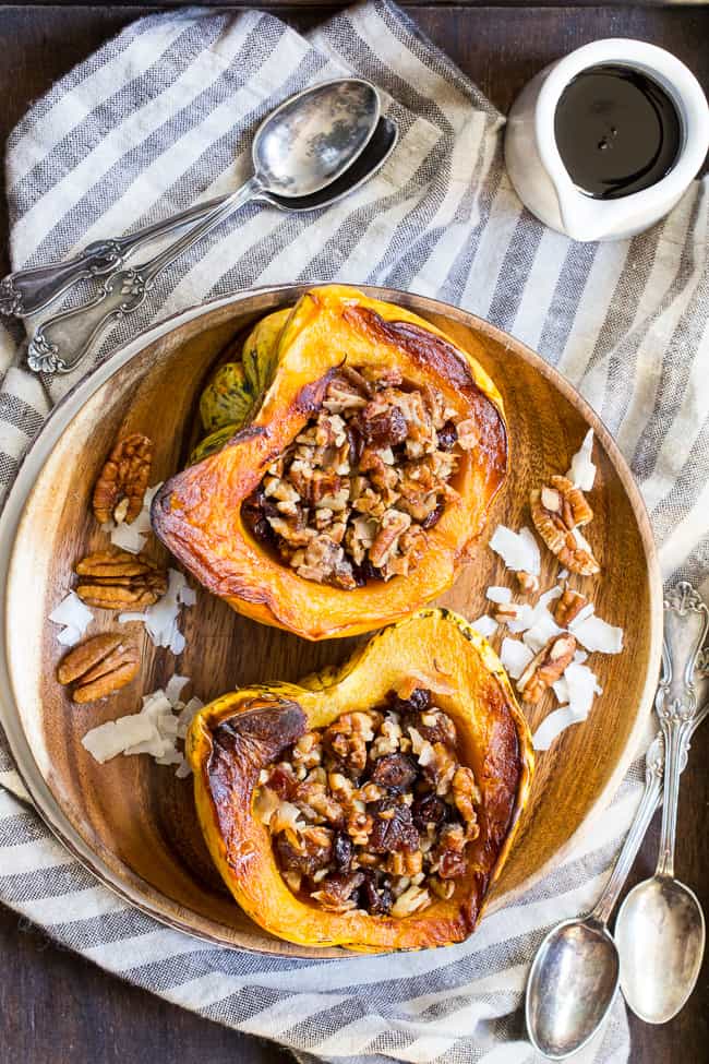 Winter squash is roasted, filled with a sweet "candy" mixture, drizzled with maple and roasted again to combine flavors.  This paleo and vegan roasted squash recipe is perfect as a sweet side dish for the holidays, or a dessert!