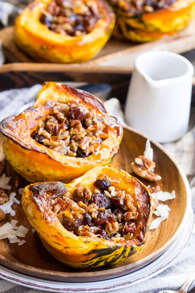 Winter squash is roasted, filled with a sweet "candy" mixture, drizzled with maple and roasted again to combine flavors.  This paleo and vegan roasted squash recipe is perfect as a sweet side dish for the holidays, or a dessert!