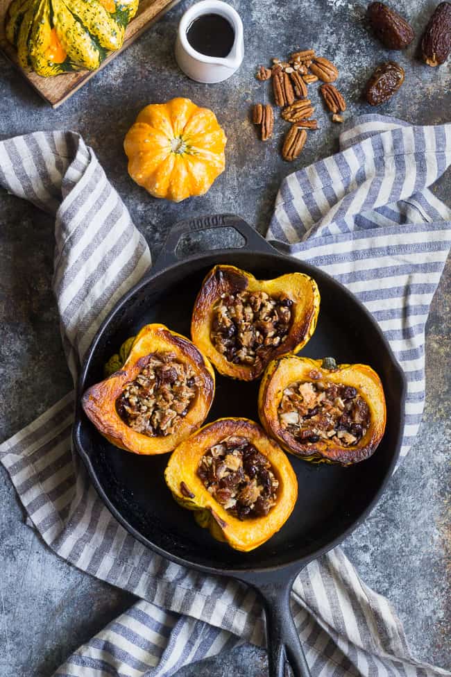 Winter squash is roasted, filled with a sweet "candy" mixture, drizzled with maple and roasted again to combine flavors.  This paleo and vegan roasted squash recipe is perfect as a sweet side dish for the holidays, or a dessert!