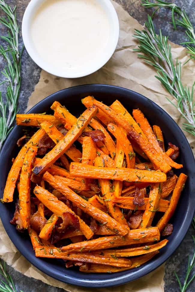 These carrot fries are roasted to crispy perfection with rosemary and tossed with savory crumbled bacon for a fun and healthy appetizer, snack or side dish! Paleo, Whole30 compliant and low carb.