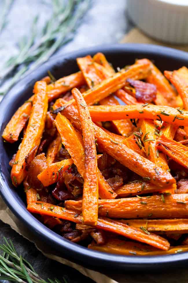 These carrot fries are roasted to crispy perfection with rosemary and tossed with savory crumbled bacon for a fun and healthy appetizer, snack or side dish! Paleo, Whole30 compliant and low carb.