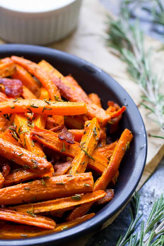 These carrot fries are roasted to crispy perfection with rosemary and tossed with savory crumbled bacon for a fun and healthy appetizer, snack or side dish! Paleo, Whole30 compliant and low carb.