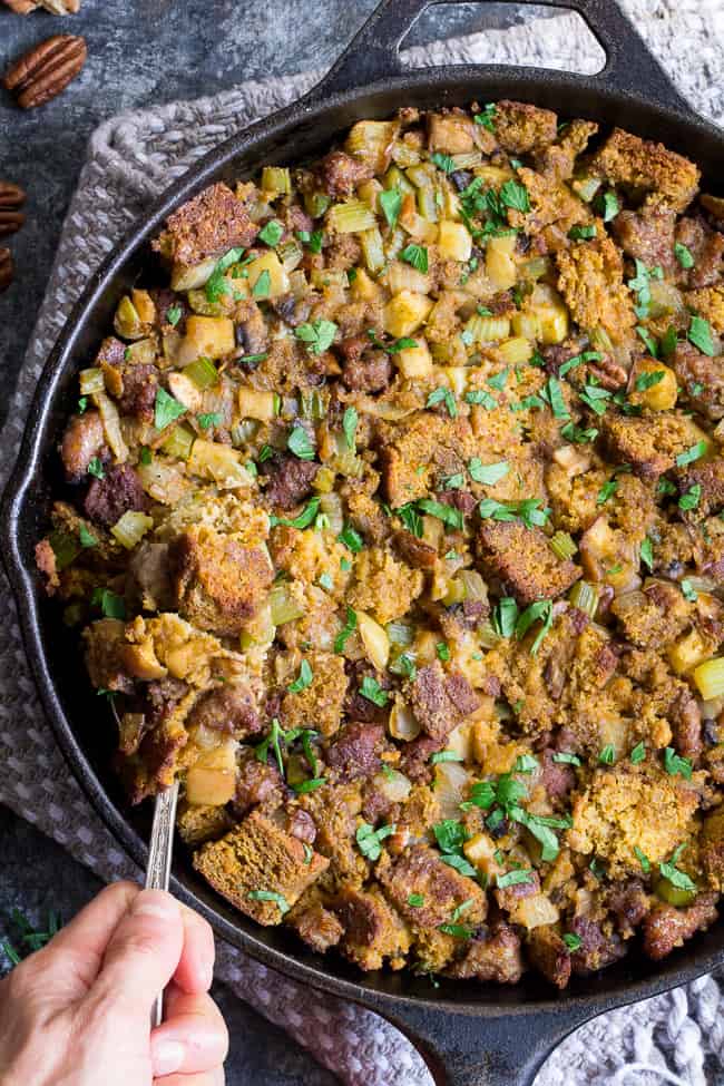 This savory and sweet "cornbread" Paleo Thanksgiving Stuffing is for all of you who want to keep with clean but still crave some bread in your stuffing!  A grain-free, dairy-free sweet potato bread is cubed and baked with sausage, apples, celery and onion, mushrooms, pecans and herbs for a delicious, filling and healthy Thanksgiving stuffing reminiscent of the classic.