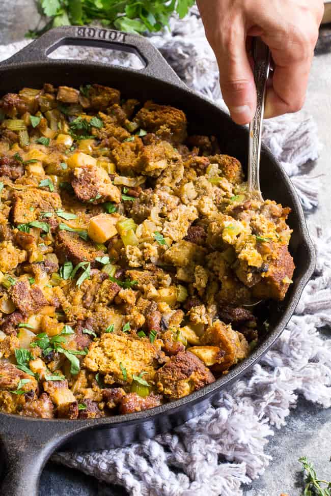 This savory and sweet "cornbread" Paleo Thanksgiving Stuffing is for all of you who want to keep with clean but still crave some bread in your stuffing!  A grain-free, dairy-free sweet potato bread is cubed and baked with sausage, apples, celery and onion, mushrooms, pecans and herbs for a delicious, filling and healthy Thanksgiving stuffing reminiscent of the classic.