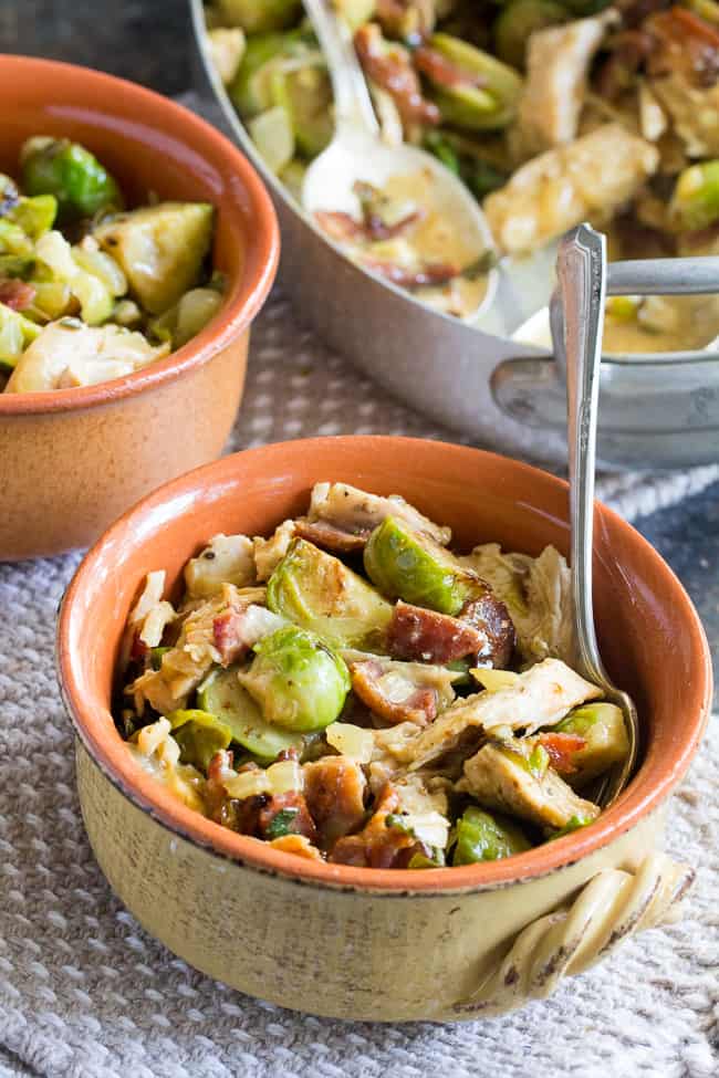 Roasted chicken and brussels sprouts are tossed with crispy bacon and baked in a creamy dairy free sauce for a super comforting, delicious and filling Whole30, paleo, and low carb meal. 