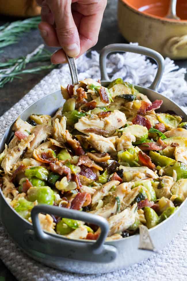 Roasted chicken and brussels sprouts are tossed with crispy bacon and baked in a creamy dairy free sauce for a super comforting, delicious and filling Whole30, paleo, and low carb meal. 