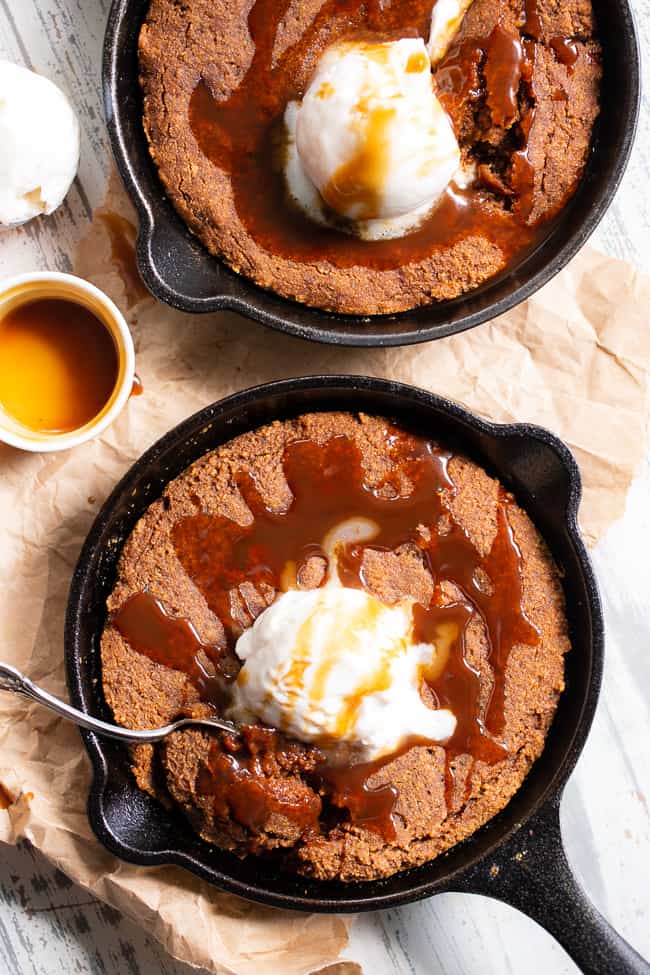This fudgy pumpkin snickerdoodle skillet cookie is loaded with pumpkin spice and cinnamon, drizzled with dairy-free salted caramel sauce and topped with coconut vanilla ice cream.  This rich paleo dessert is perfect for fall and the holiday season!  Kid approved, paleo, dairy-free, grain-free.