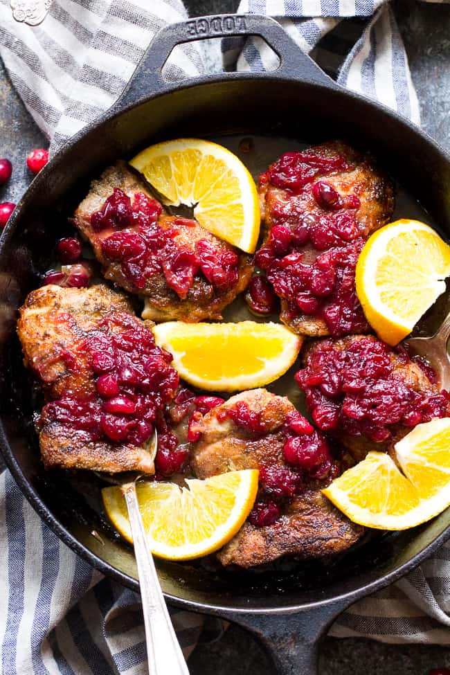 We take crisp, savory spiced chicken thighs and a healthy, refined sugar free orange cranberry sauce and bake them together to delicious perfection!  This Paleo Orange Cranberry Chicken is easy to make, gluten-free, dairy-free, and has a Whole30 friendly option.