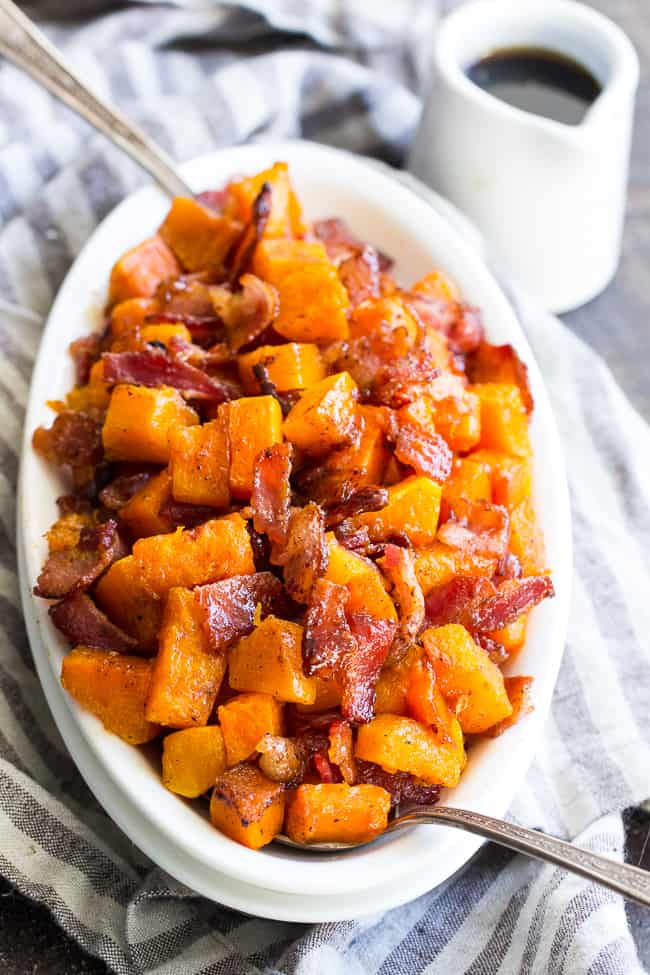 This easy and delicious, sweet and savory maple bacon roasted butternut squash is everything you're craving!  Golden roasted butternut with crisp savory bacon and sweet maple cinnamon make this cozy side dish downright addicting and perfect to go with any meal.  Great for the holidays too!  Paleo and refined sugar free.