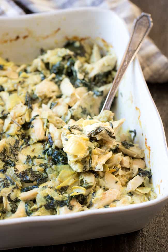 This creamy hot spinach artichoke dip has shredded chicken for extra protein, so you can easily make it part of a healthy paleo or Whole30 meal!  Perfect with veggies, over a baked potato or with sweet potato toast.  Dairy free, paleo, Whole30 compliant, low carb and keto friendly.