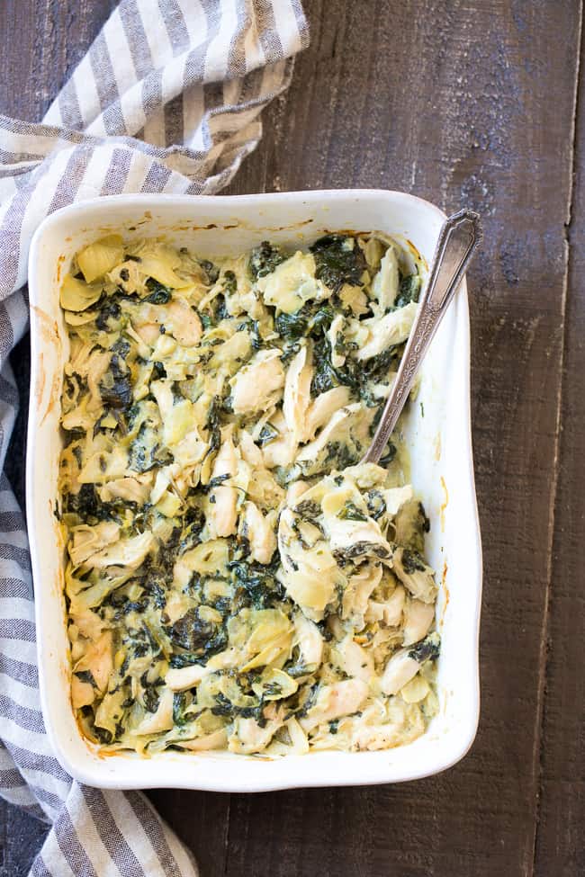 This creamy hot spinach artichoke dip has shredded chicken for extra protein, so you can easily make it part of a healthy paleo or Whole30 meal!  Perfect with veggies, over a baked potato or with sweet potato toast.  Dairy free, paleo, Whole30 compliant, low carb and keto friendly.