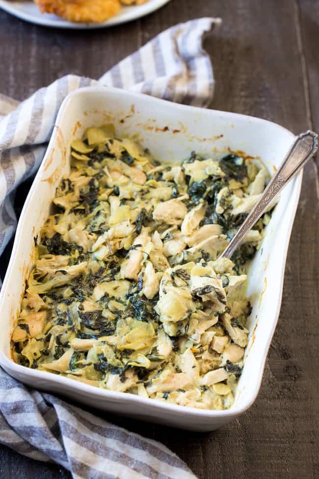 This creamy hot spinach artichoke dip has shredded chicken for extra protein, so you can easily make it part of a healthy paleo or Whole30 meal!  Perfect with veggies, over a baked potato or with sweet potato toast.  Dairy free, paleo, Whole30 compliant, low carb and keto friendly.